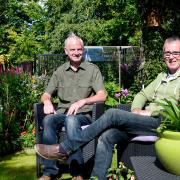 David and Tom sit, for once, and enjoy the garden they have created together.